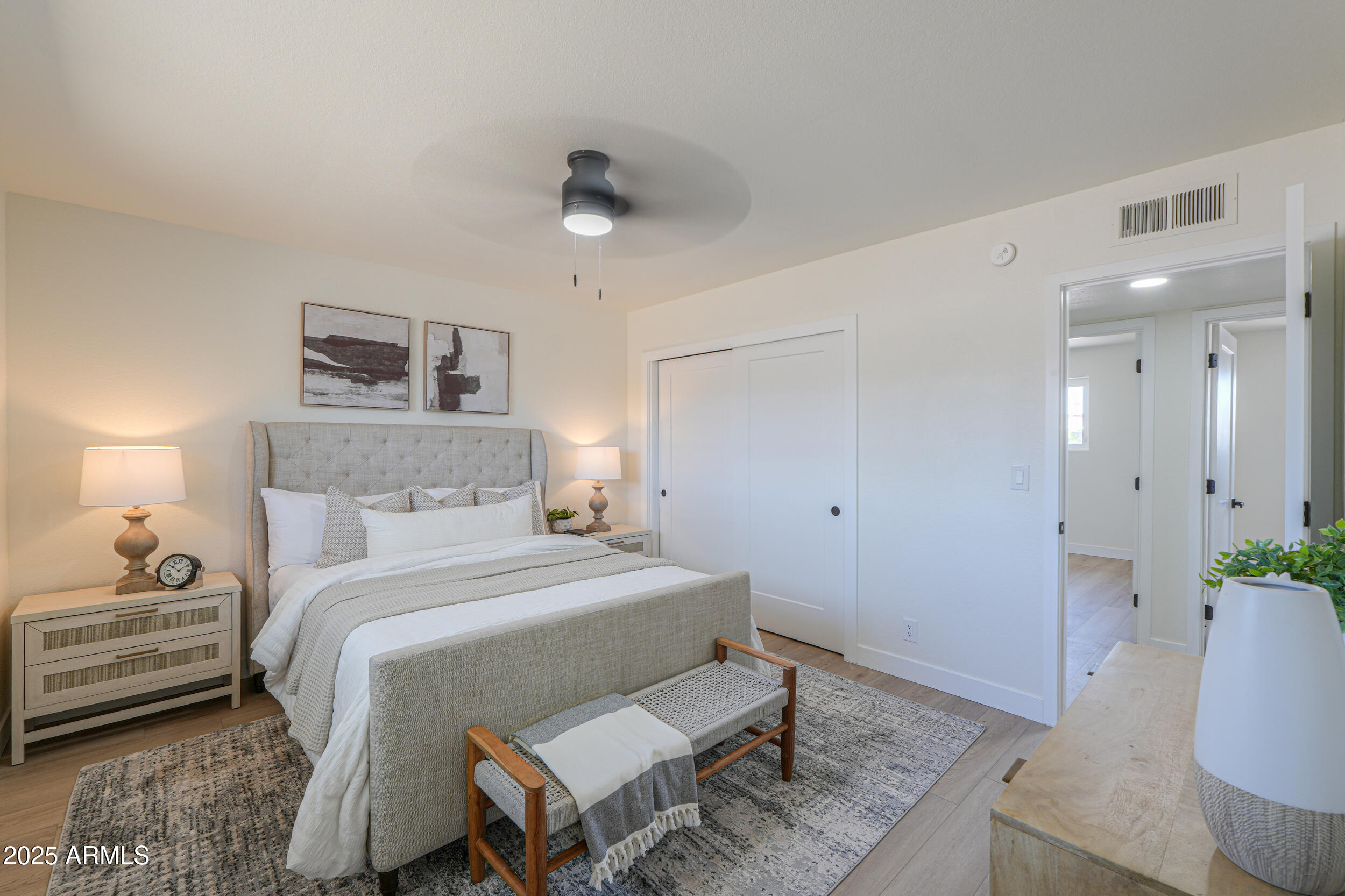 6502 East Rustic Drive Mesa, AZ 85215 - Photo 17 of 40 a bedroom with a bed and wooden floor