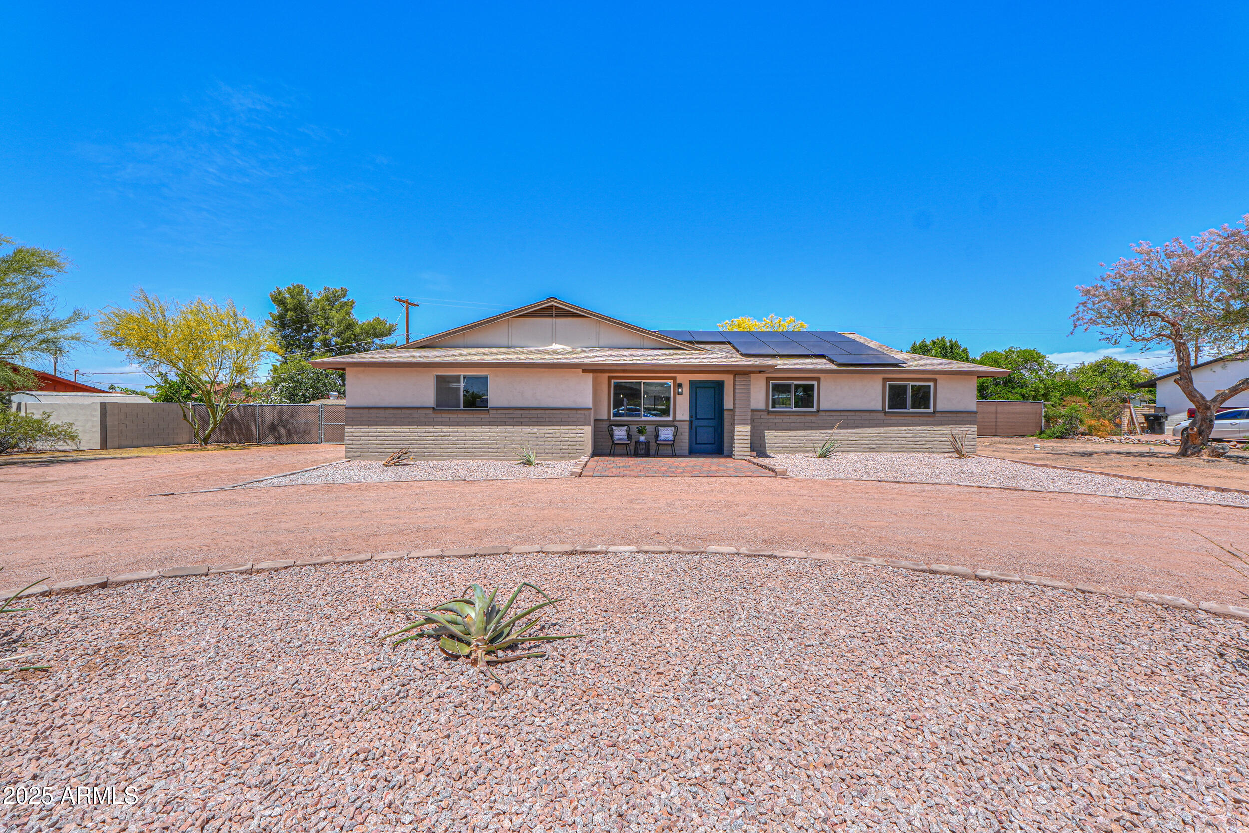 6502 East Rustic Drive Mesa, AZ 85215 - Photo 2 of 40 a front view of a house with a yard and a garage