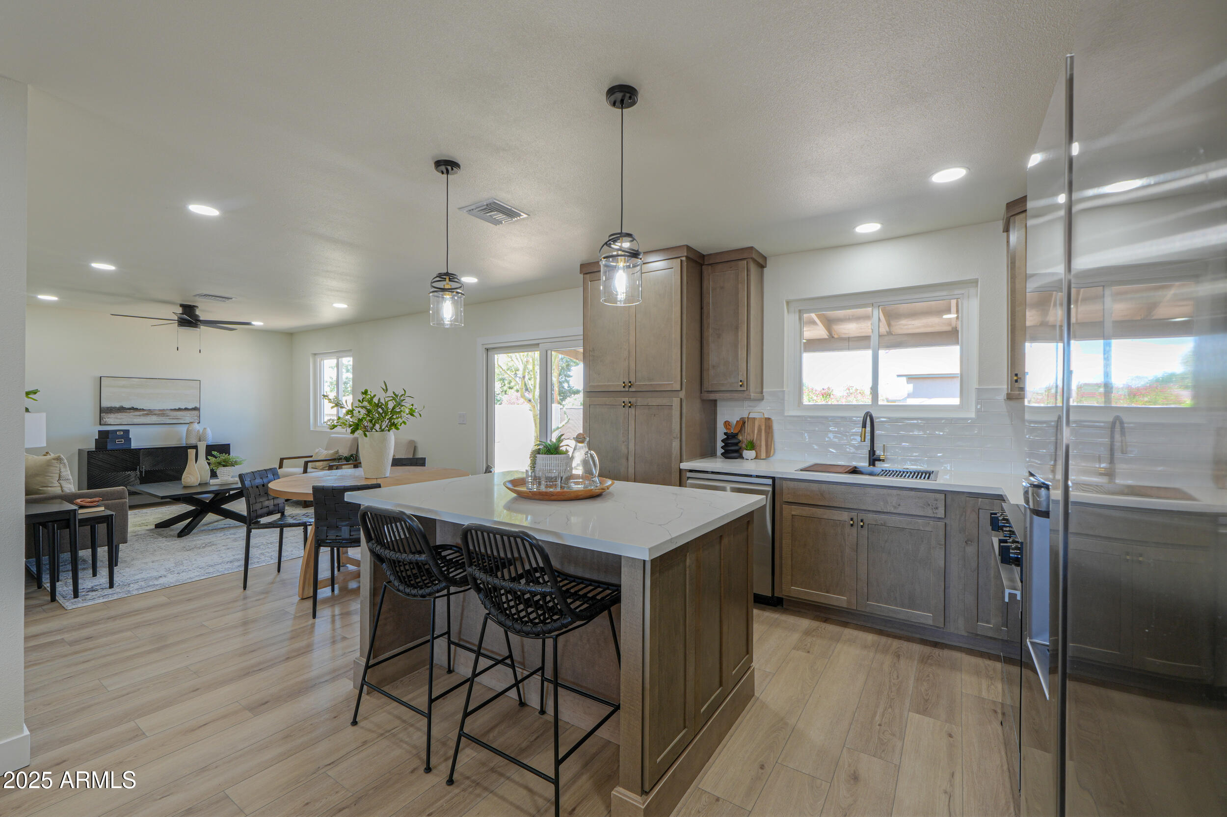 6502 East Rustic Drive Mesa, AZ 85215 - Photo 6 of 40 a kitchen with stainless steel appliances granite countertop table chairs stove refrigerator and cabinets
