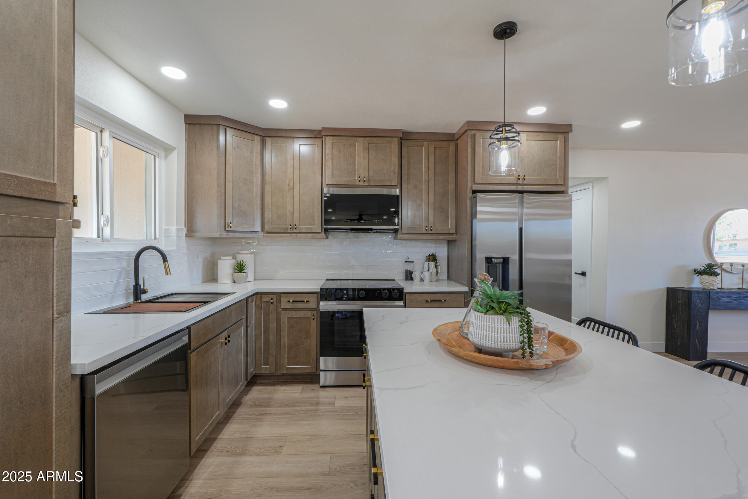 6502 East Rustic Drive Mesa, AZ 85215 - Photo 10 of 40 a kitchen with a sink a stove and chairs