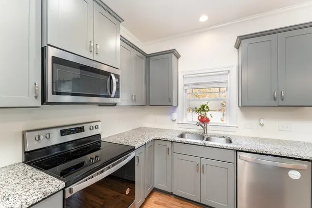 a kitchen with a sink stove and microwave