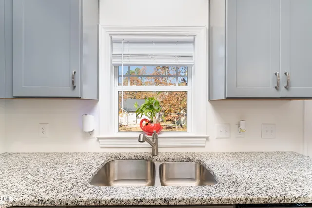 a kitchen with a sink cabinets and a window