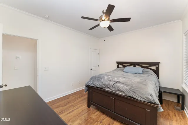 a bed sitting in a room next to a window