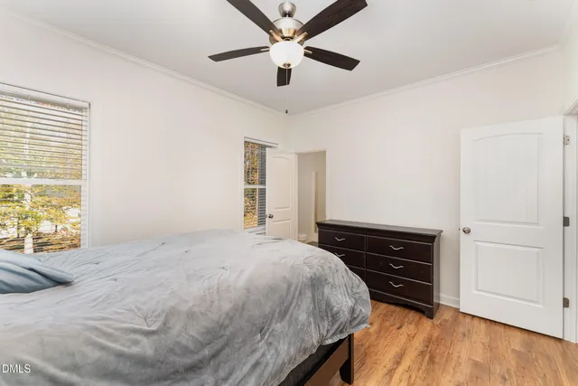 a bedroom with a bed and a ceiling fan