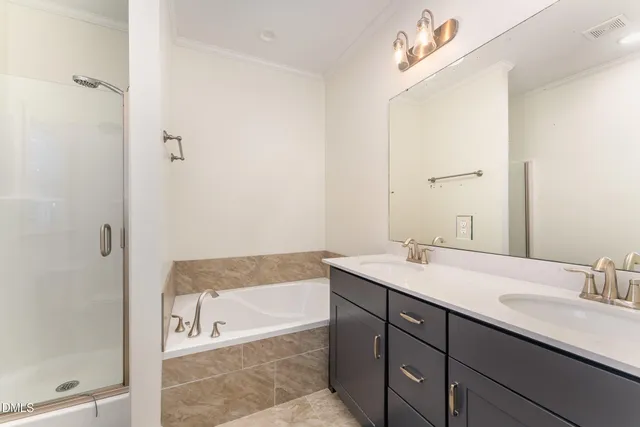 a bathroom with a tub sink and mirror