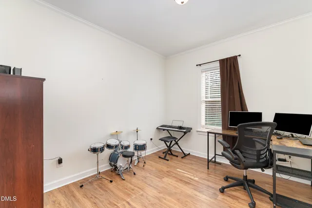 a view of a workspace with furniture and a window