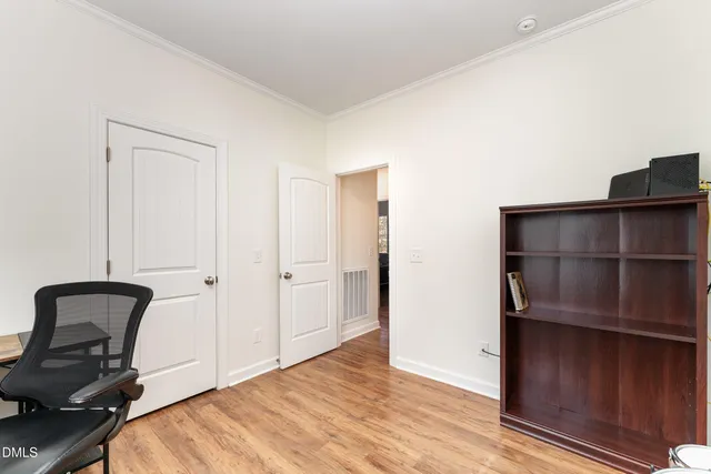 a view of an empty room and wooden floor