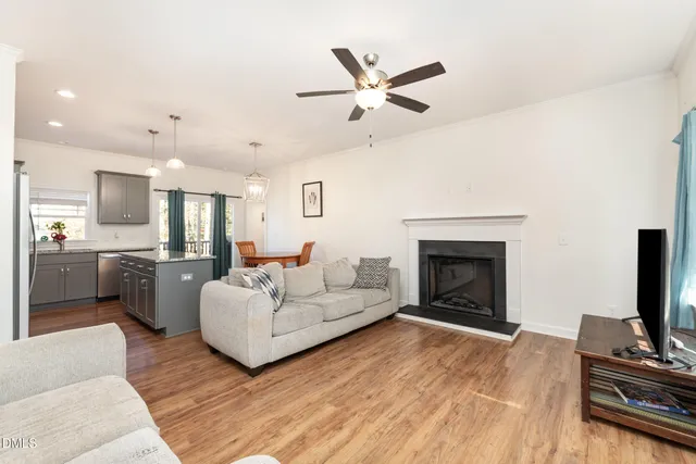 a living room with furniture fireplace and flat screen tv
