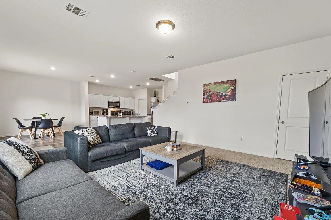 19605 Caymus Drive Pflugerville, TX 78660 - Photo 5 of 26 Living room featuring recessed lighting and stairway