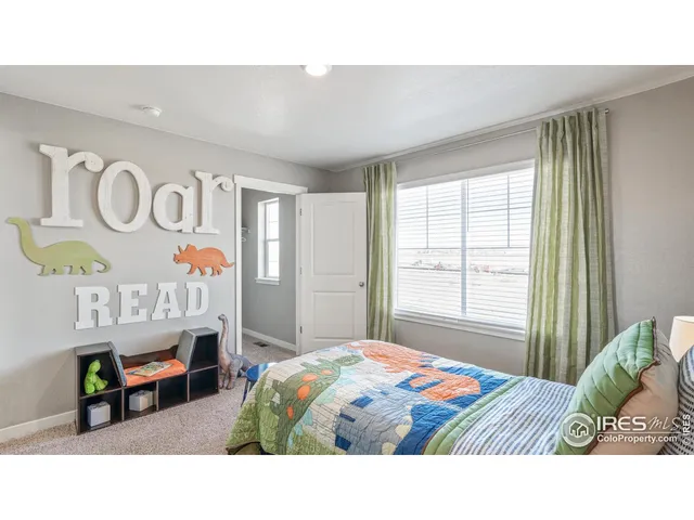 a bedroom with a bed a mirror and a window