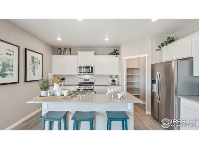 a kitchen with stainless steel appliances kitchen island granite countertop a kitchen island and chairs