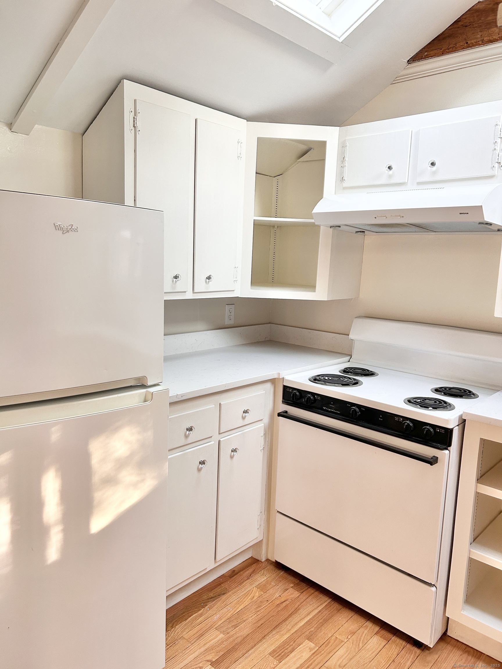 6-5 5th Street, Unit 6 Madison, CT 06443 - Photo 11 of 29 a kitchen with granite countertop white cabinets and white appliances