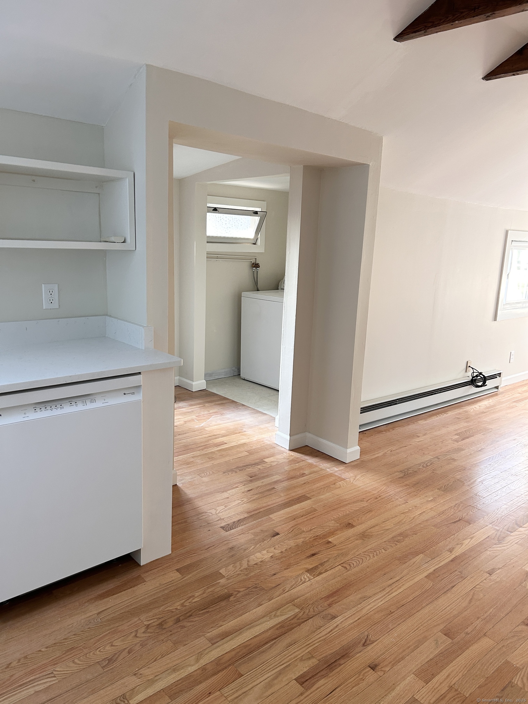 6-5 5th Street, Unit 6 Madison, CT 06443 - Photo 12 of 29 a view of an empty room with wooden floor and a window