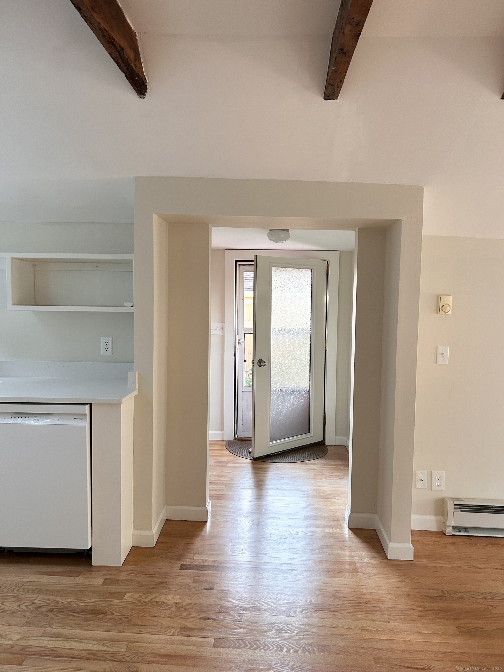 6-5 5th Street, Unit 6 Madison, CT 06443 - Photo 13 of 29 a view of a livingroom with wooden floor and a window