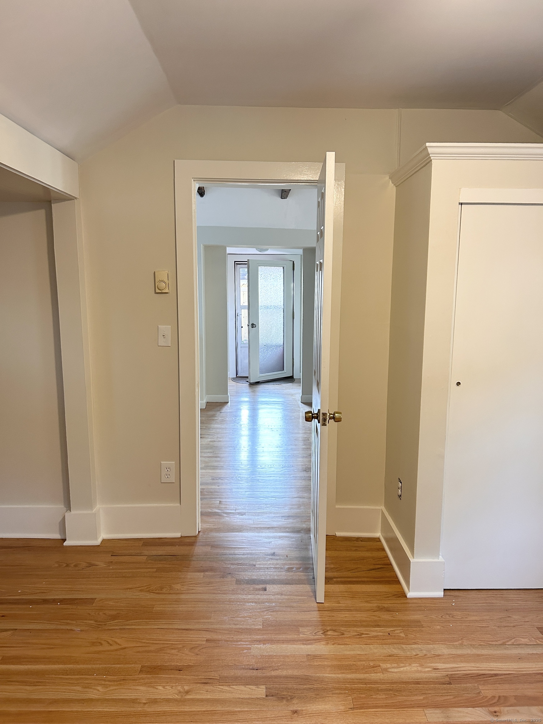 6-5 5th Street, Unit 6 Madison, CT 06443 - Photo 14 of 29 a view of a hallway with wooden floor and a cabinet