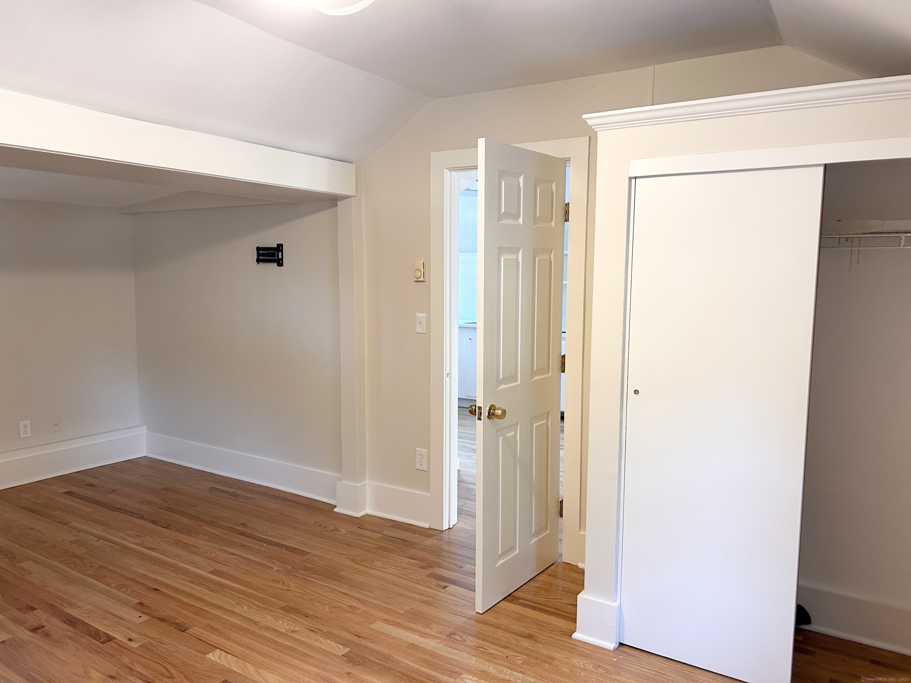 6-5 5th Street, Unit 6 Madison, CT 06443 - Photo 15 of 29 a view of a hallway with wooden floor