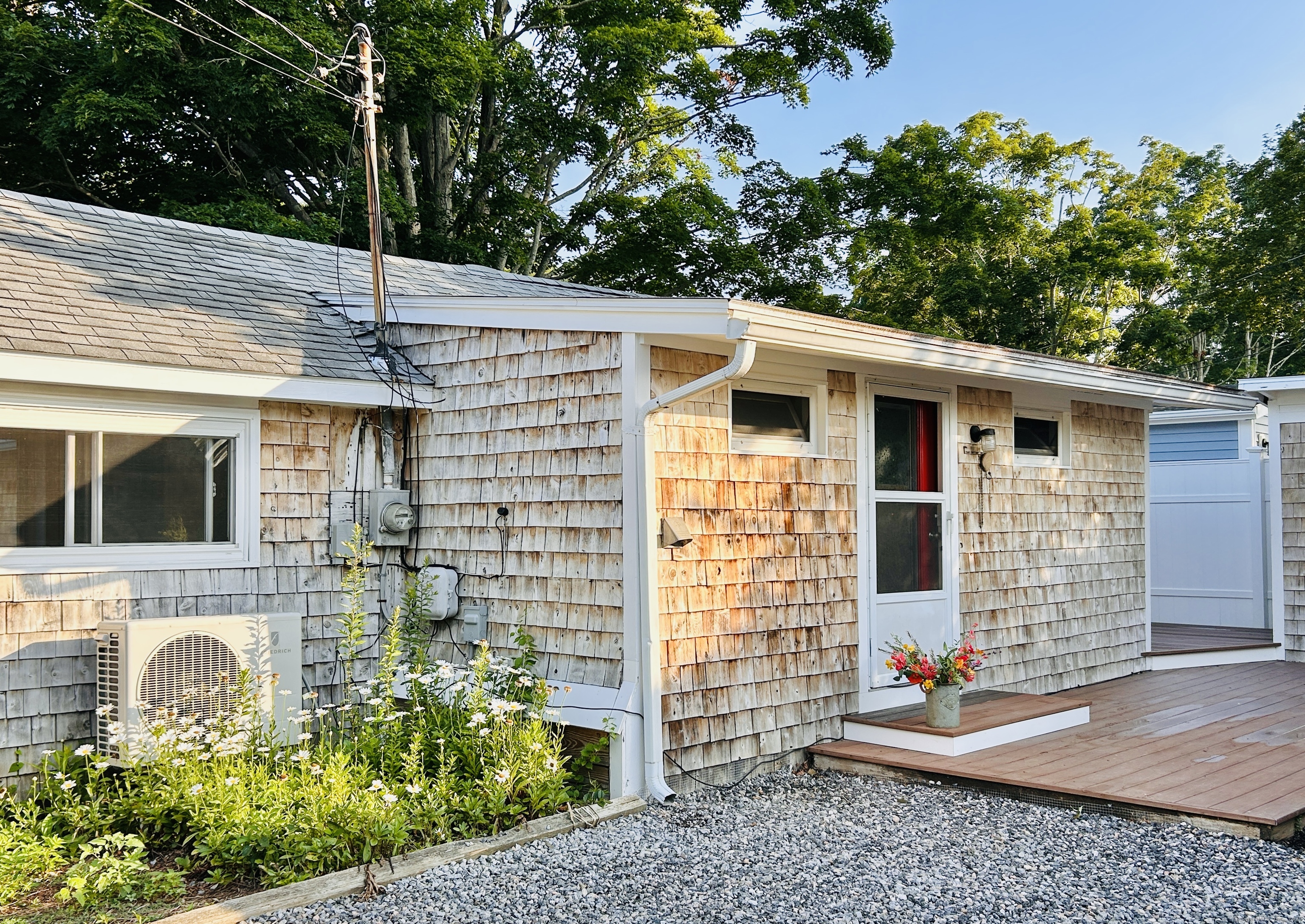 6-5 5th Street, Unit 6 Madison, CT 06443 - Photo 2 of 29 a front view of a house with garden