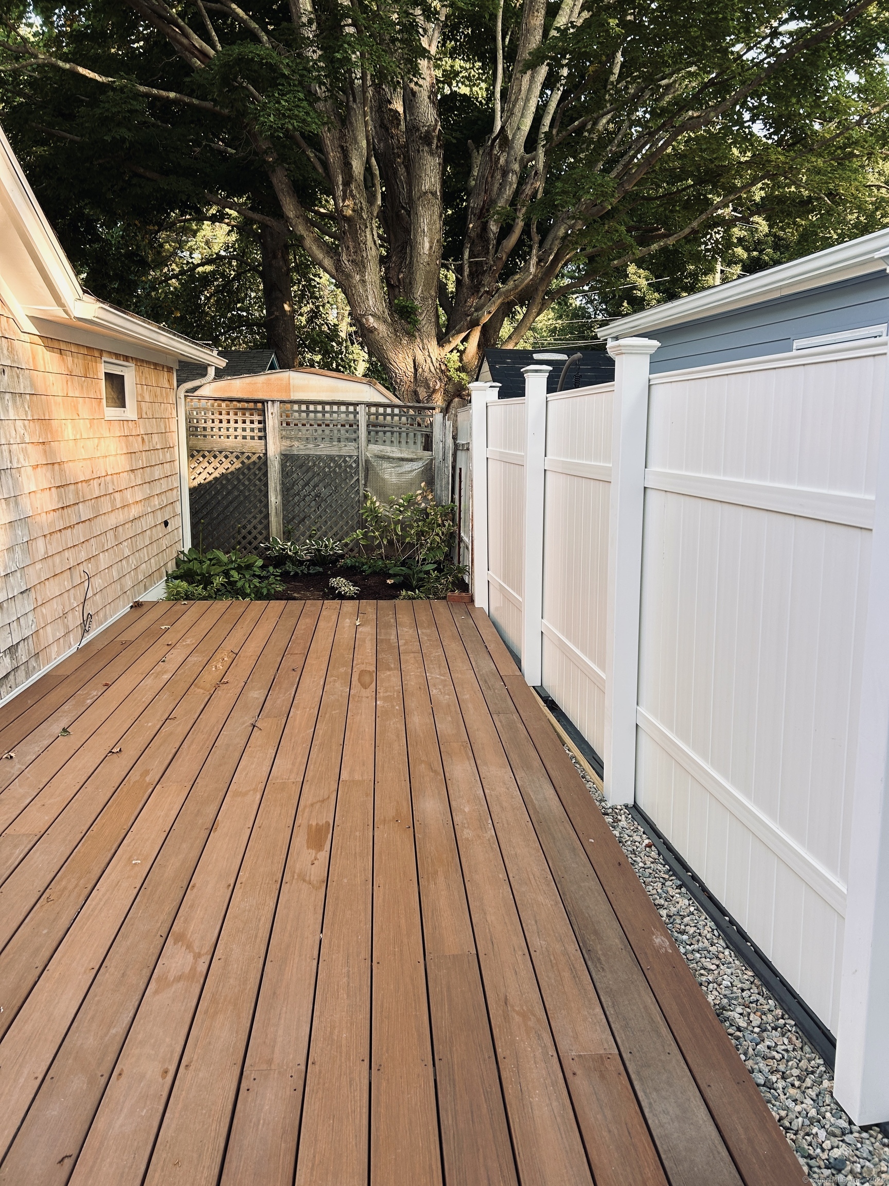 6-5 5th Street, Unit 6 Madison, CT 06443 - Photo 22 of 29 a view of backyard with small cabin