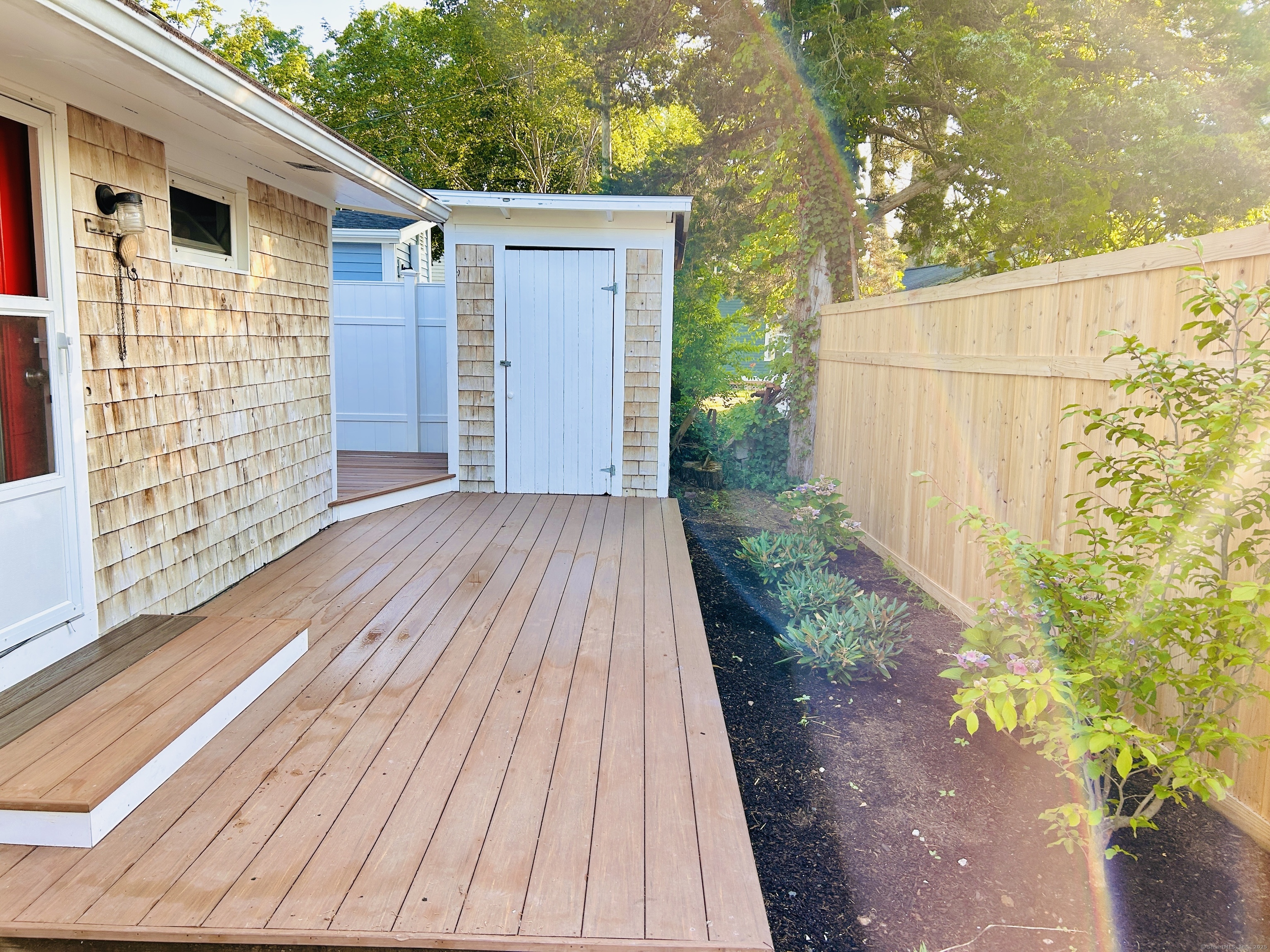 6-5 5th Street, Unit 6 Madison, CT 06443 - Photo 24 of 29 a view of backyard with small cabin