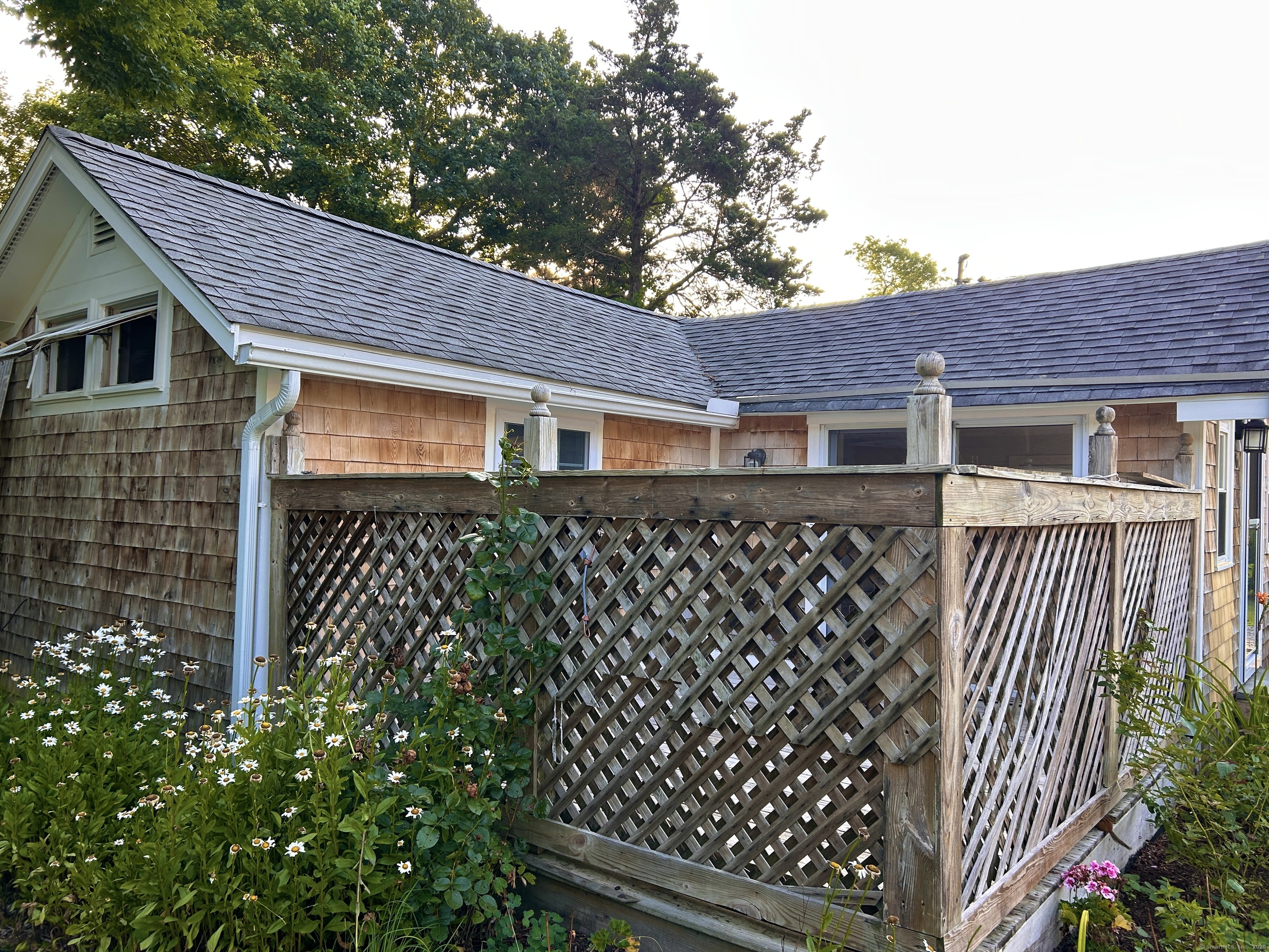 6-5 5th Street, Unit 6 Madison, CT 06443 - Photo 4 of 29 a front view of a house with a garden