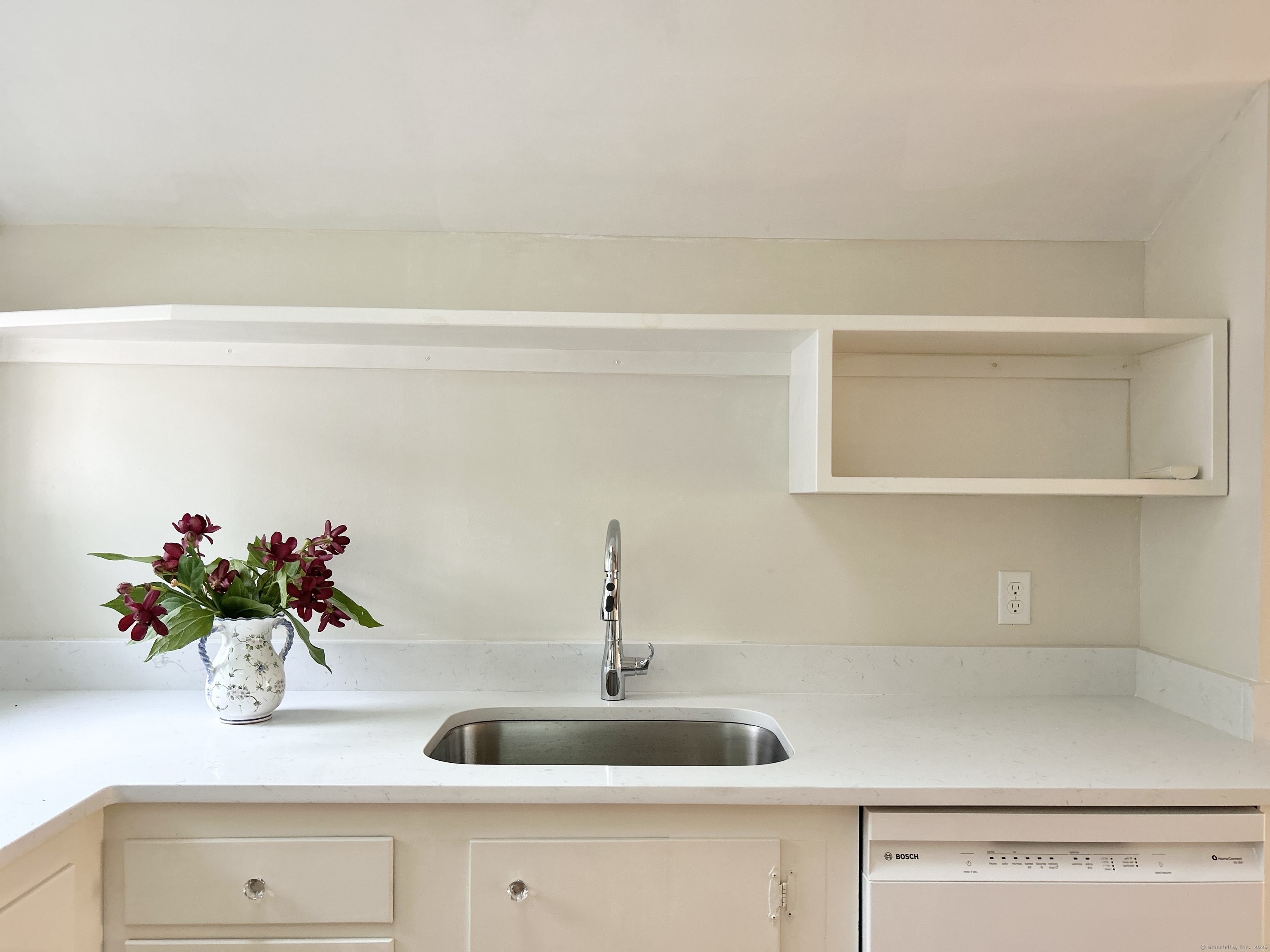 6-5 5th Street, Unit 6 Madison, CT 06443 - Photo 6 of 29 a bathroom with a sink and a mirror