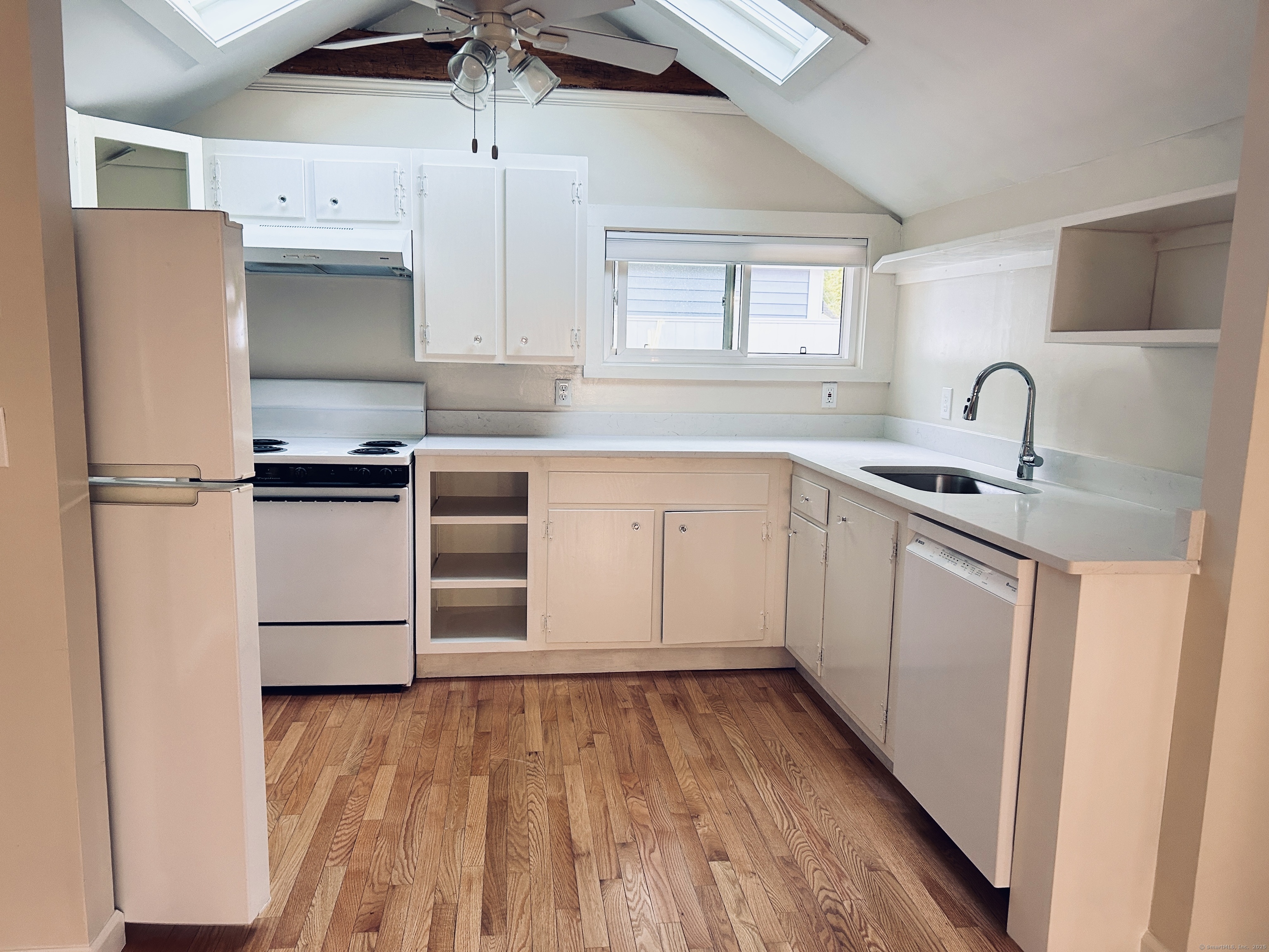 6-5 5th Street, Unit 6 Madison, CT 06443 - Photo 9 of 29 a kitchen with stainless steel appliances a refrigerator sink and cabinets