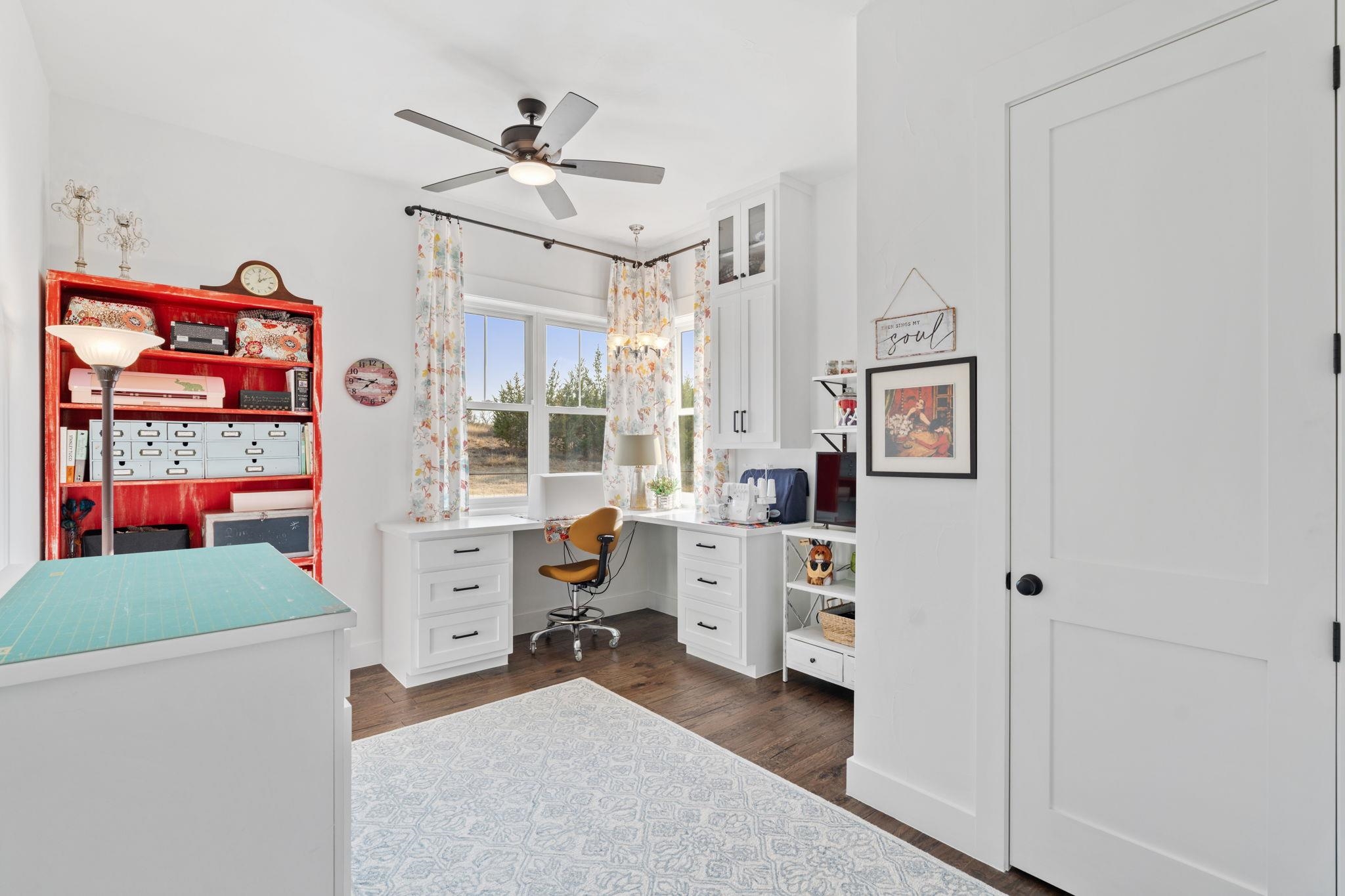 452 Southwick Ranch Road Johnson City, TX 78636 - Photo 23 of 44 a view of a workspace with furniture and a window