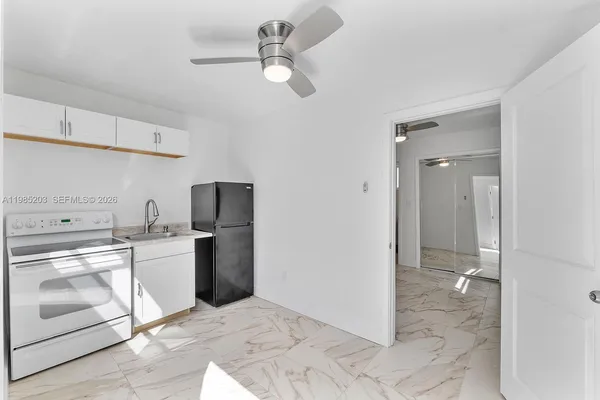 a kitchen with a stove a refrigerator and a sink
