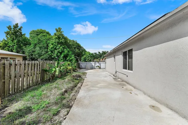 a view of a backyard with wooden fence