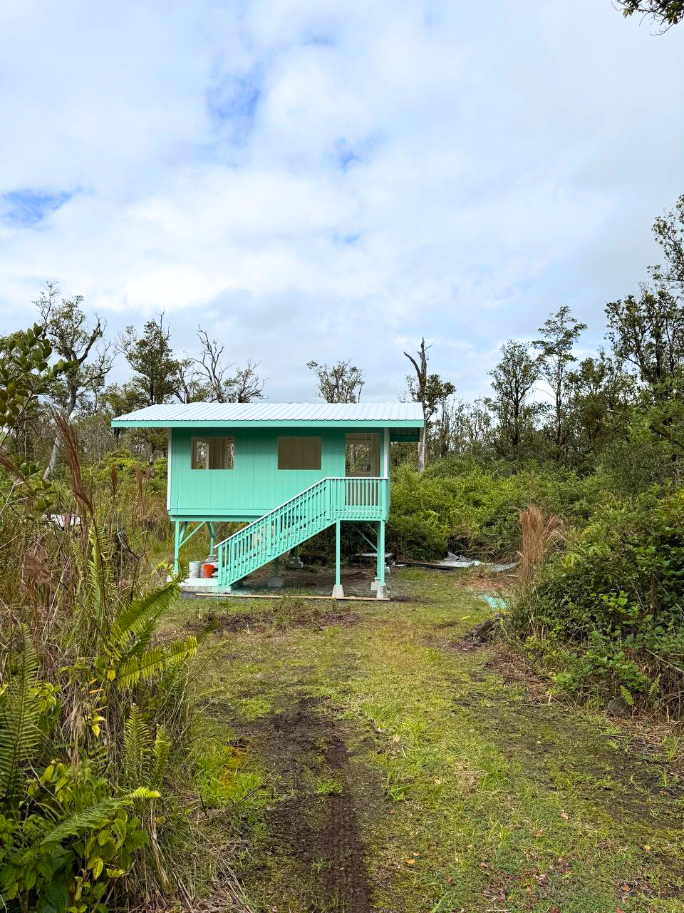 21 Palainui Street Pahoa, HI 96778 - Photo 8 of 8 a view of a wooden house with a big yard and large trees