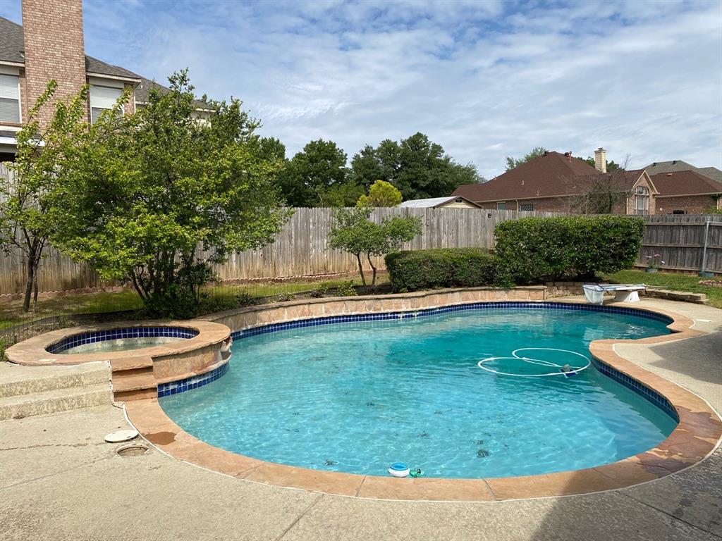 2709 St Michael Drive Mansfield, TX 76063 - Photo 1 of 1 a view of a swimming pool with a garden