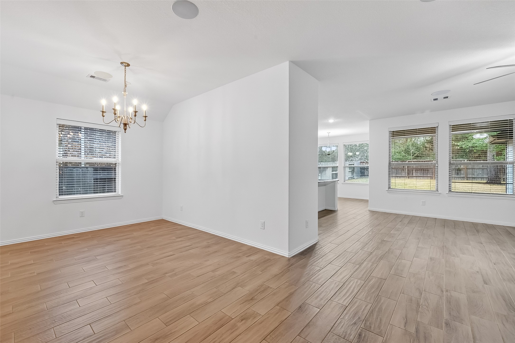 210 Emory Birch Montgomery, TX 77316 - Photo 11 of 48 wooden floor in an empty room with a window