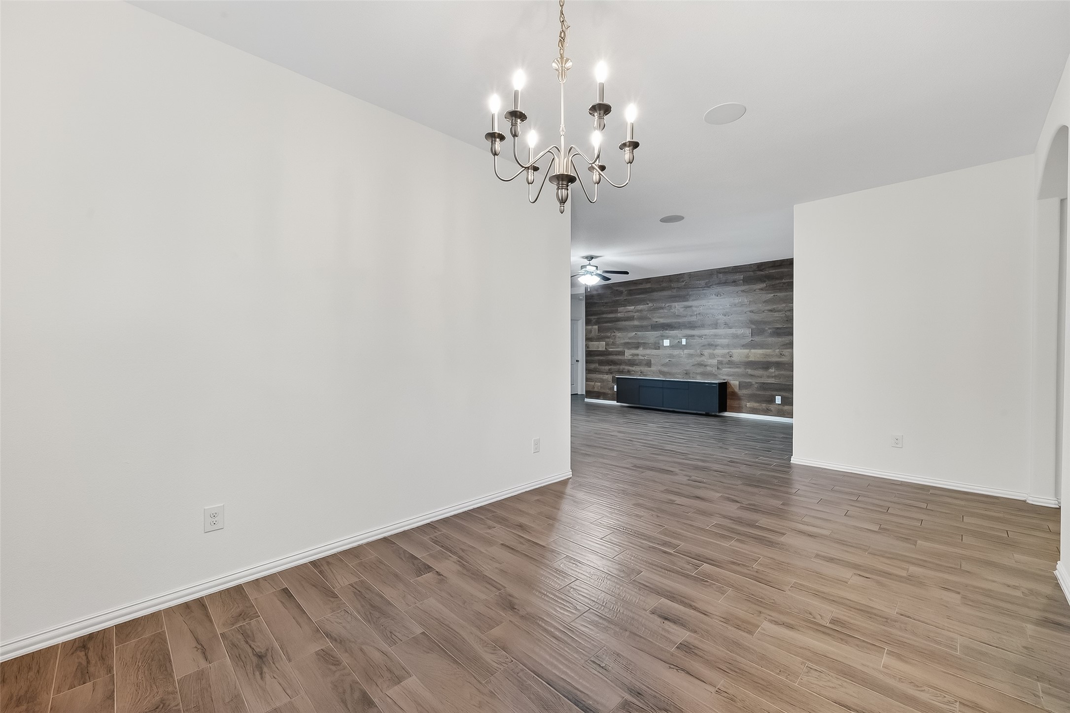 210 Emory Birch Montgomery, TX 77316 - Photo 14 of 48 a view of a room with wooden floor and chandelier