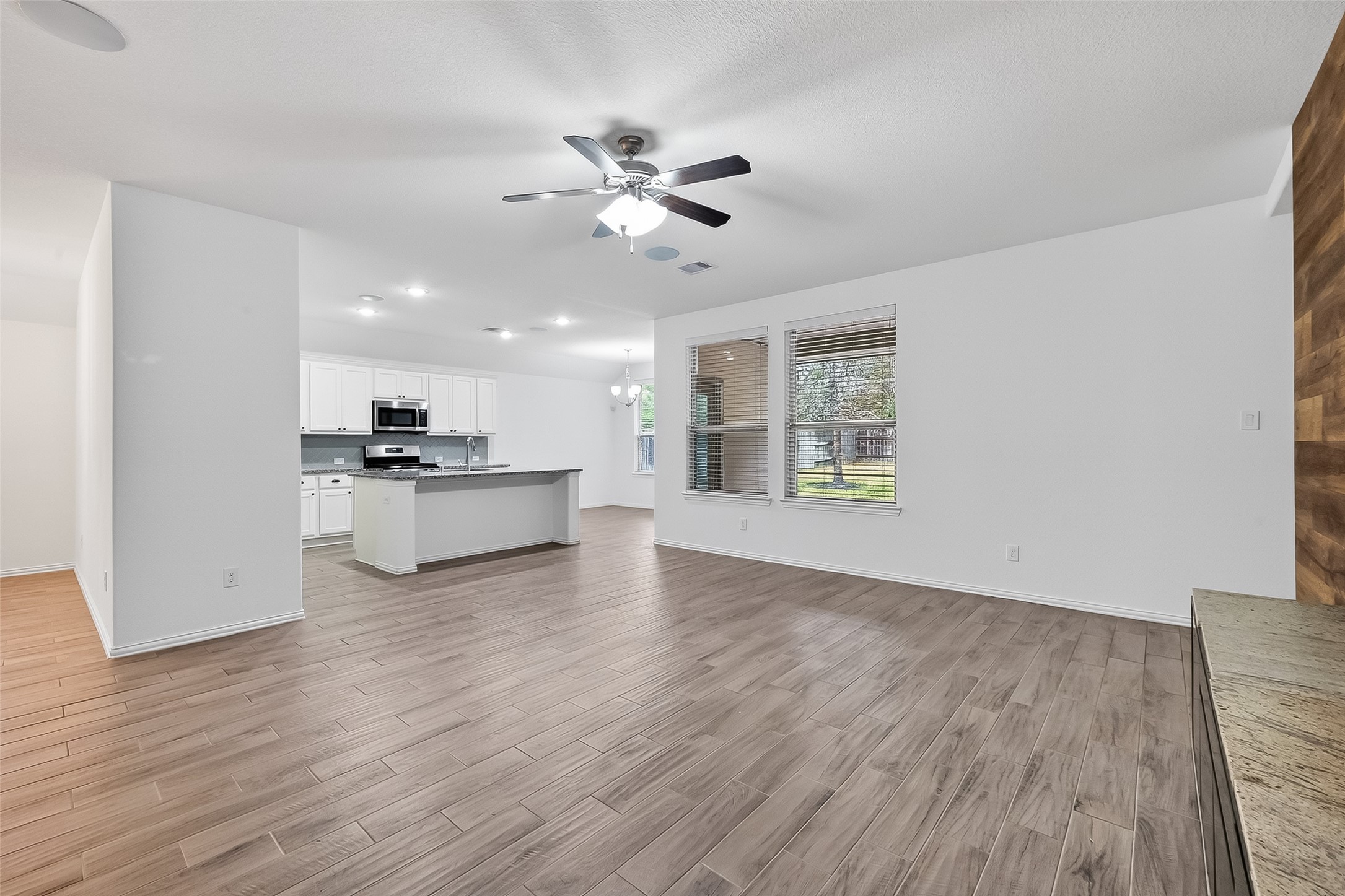 210 Emory Birch Montgomery, TX 77316 - Photo 15 of 48 a view of an empty room with wooden floor and a window