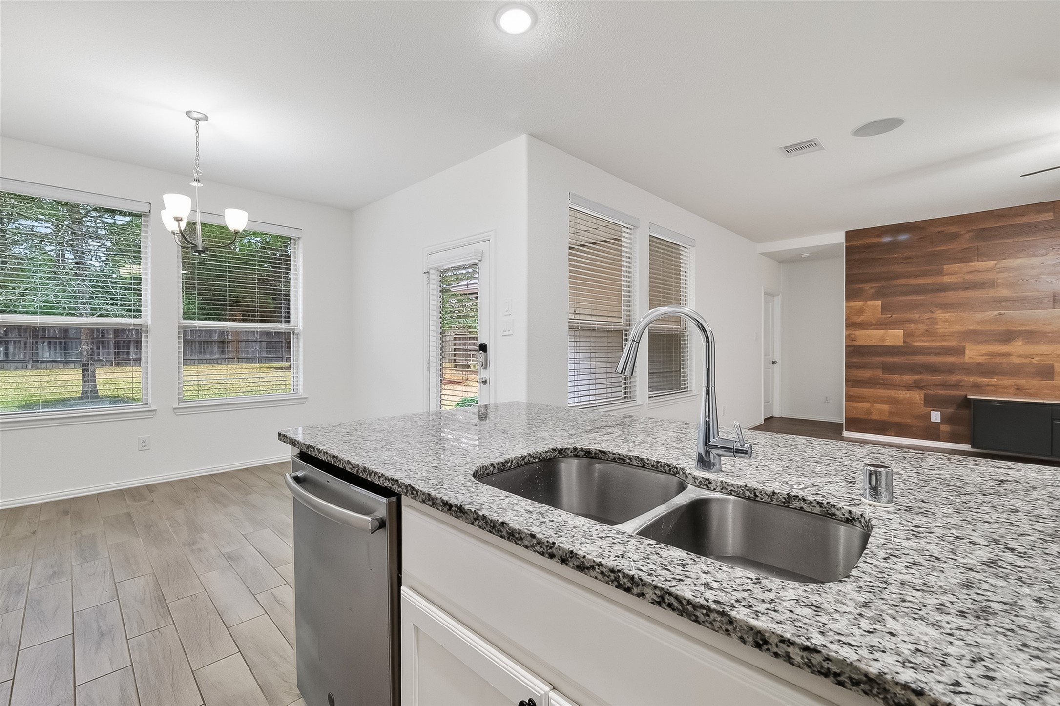 210 Emory Birch Montgomery, TX 77316 - Photo 19 of 48 a kitchen with granite countertop a sink and a wooden floor
