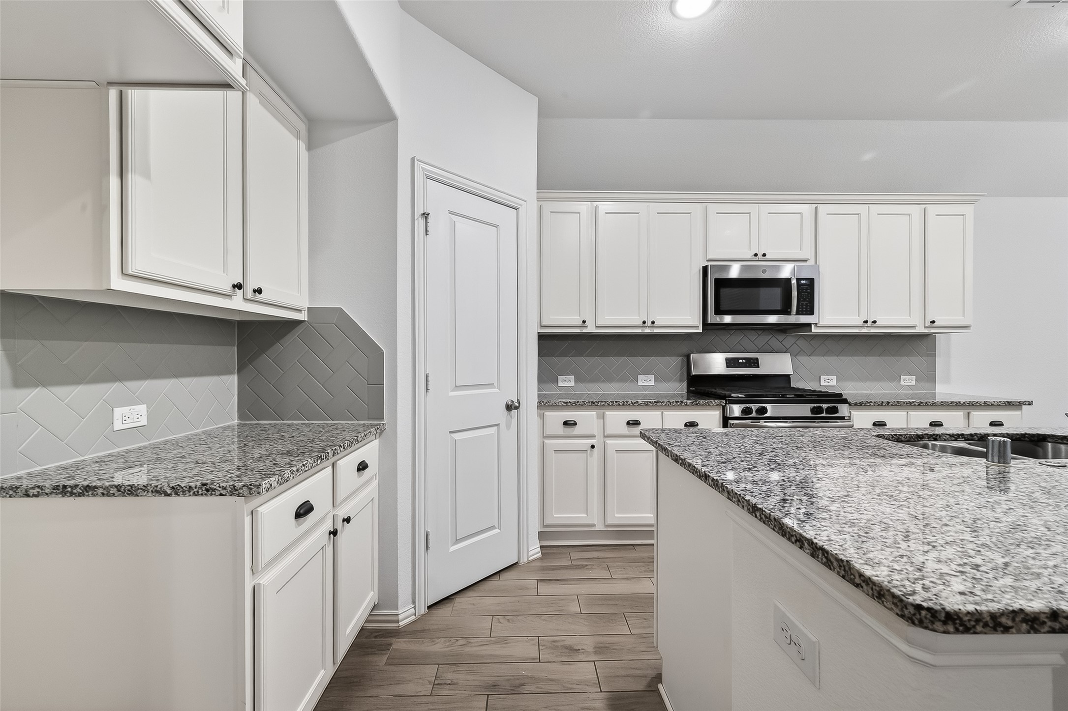 210 Emory Birch Montgomery, TX 77316 - Photo 26 of 48 a kitchen with stainless steel appliances granite countertop a stove a sink and a granite counter tops