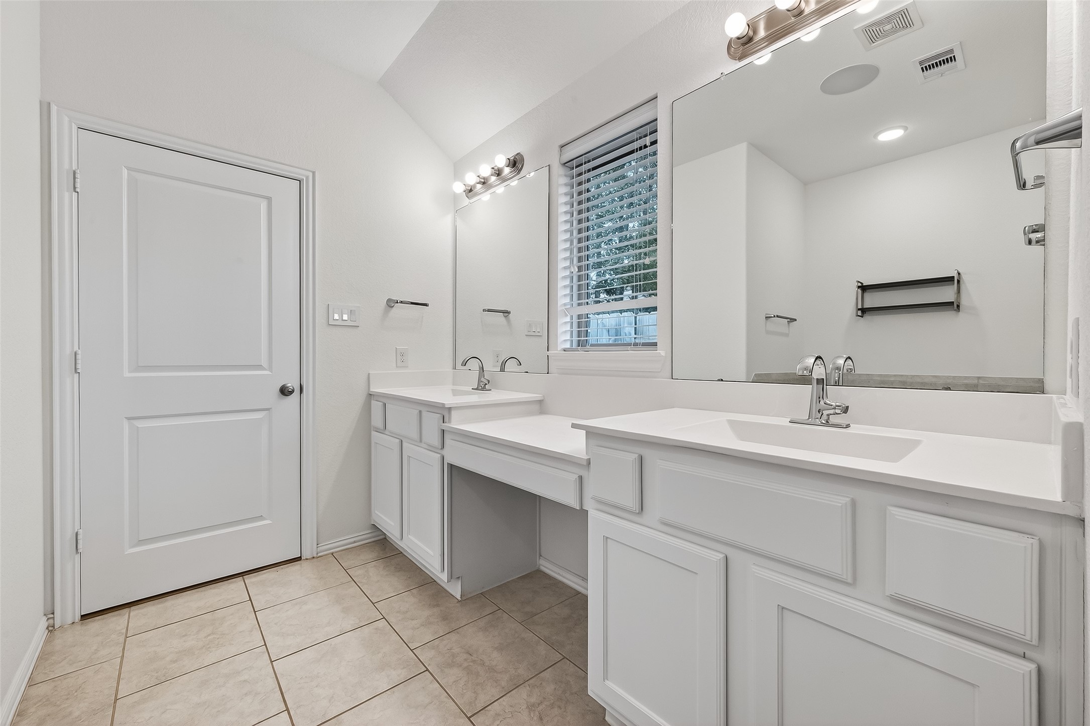 210 Emory Birch Montgomery, TX 77316 - Photo 40 of 48 a bathroom with a double vanity sink a mirror and a bathtub