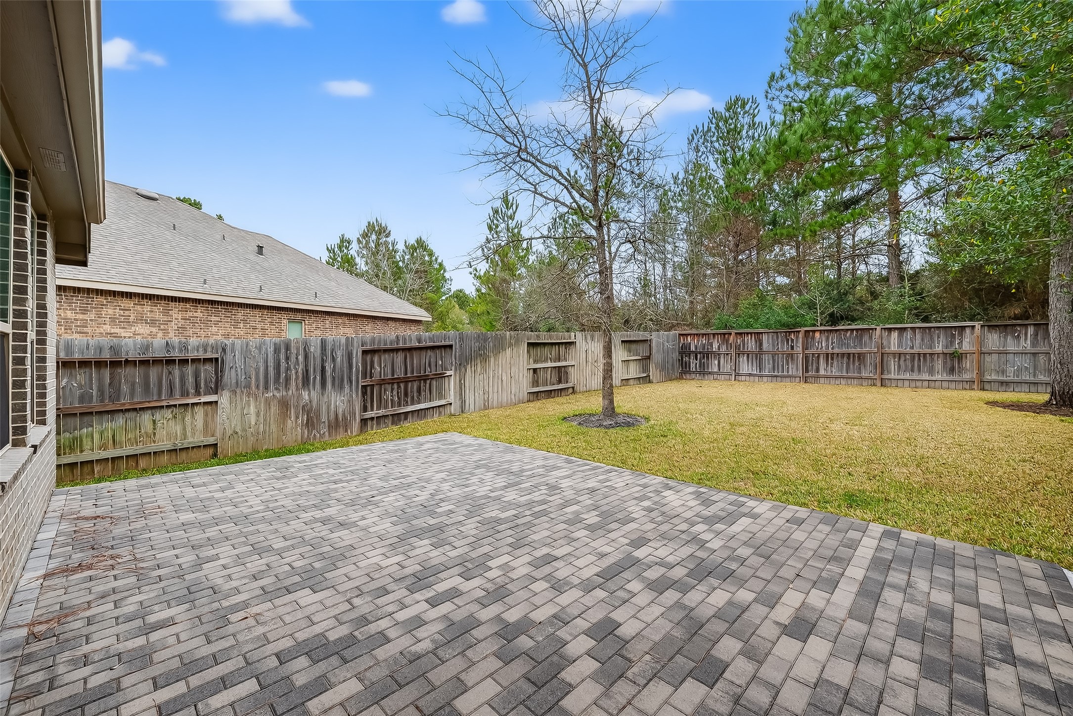 210 Emory Birch Montgomery, TX 77316 - Photo 46 of 48 a view of backyard with large trees and a wooden fence
