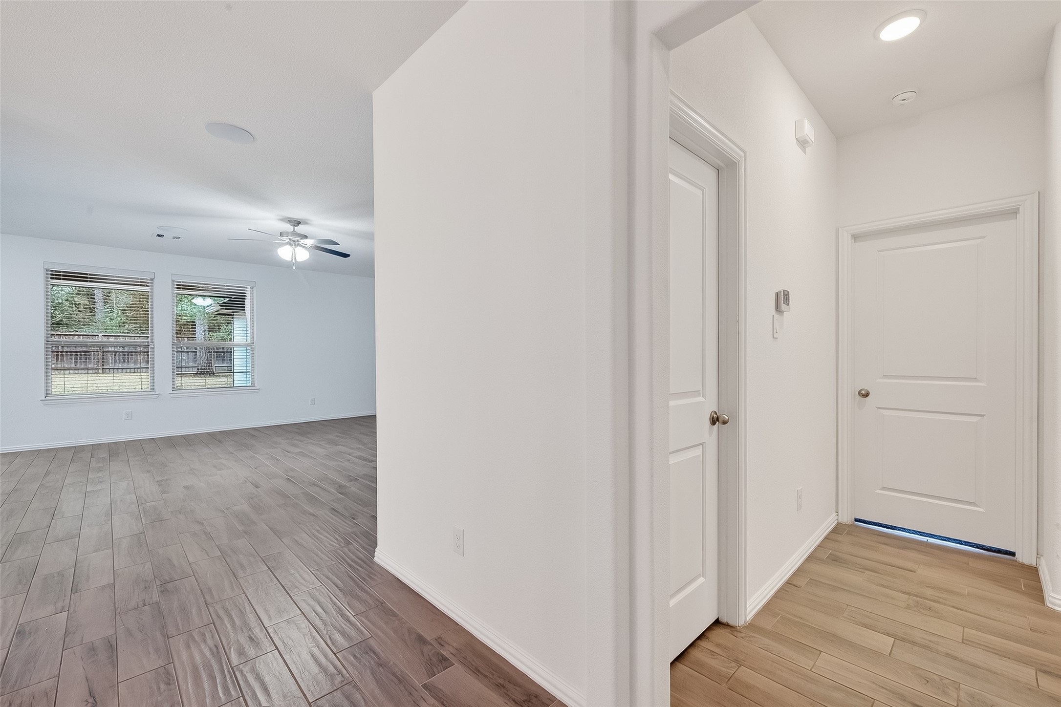 210 Emory Birch Montgomery, TX 77316 - Photo 8 of 48 wooden floor in an empty room with a window