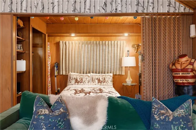 a bed sitting in a bedroom next to a window