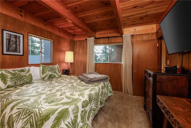 a bedroom with a bed next to a window