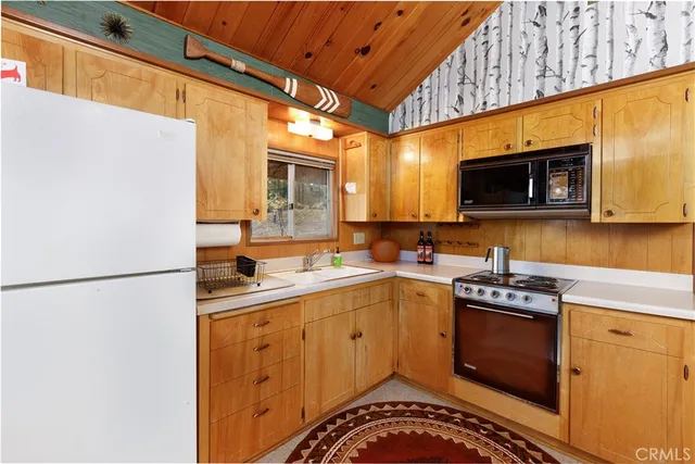 a kitchen with a sink a stove and refrigerator