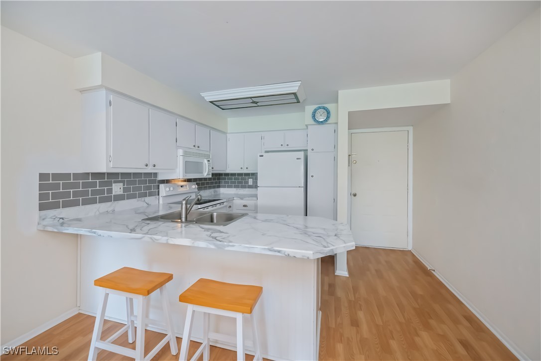1100 Pondella Road, Unit 514 Cape Coral, FL 33909 - Photo 11 of 35 a kitchen with stainless steel appliances granite countertop a sink and a cabinets