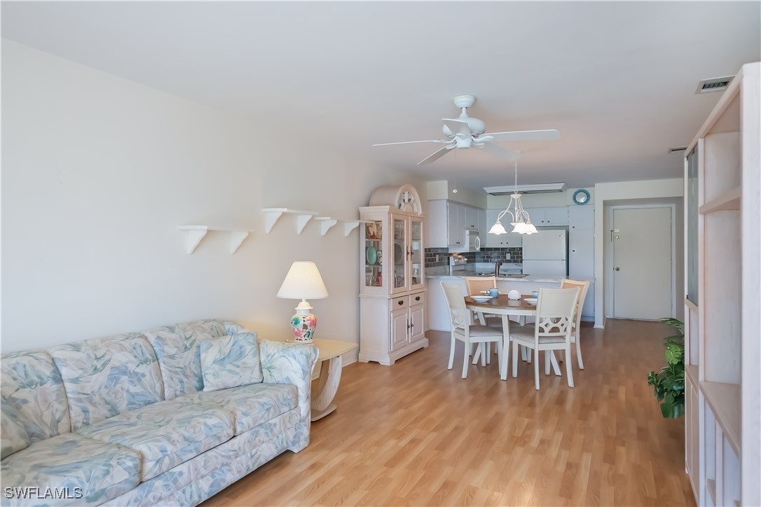 1100 Pondella Road, Unit 514 Cape Coral, FL 33909 - Photo 18 of 35 a living room with furniture and a wooden floor