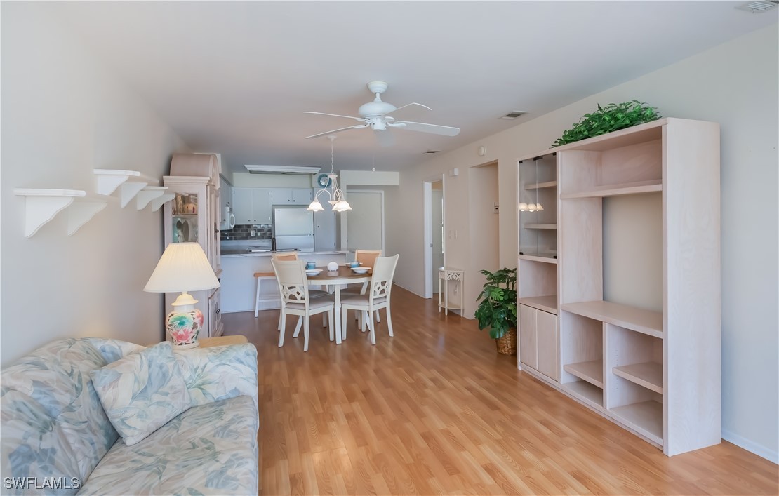 1100 Pondella Road, Unit 514 Cape Coral, FL 33909 - Photo 20 of 35 a living room with furniture and wooden floor