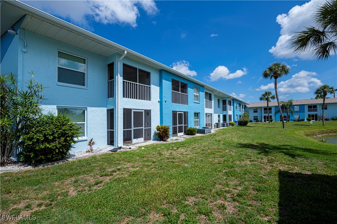 1100 Pondella Road, Unit 514 Cape Coral, FL 33909 - Photo 5 of 35 a view of a building with a yard