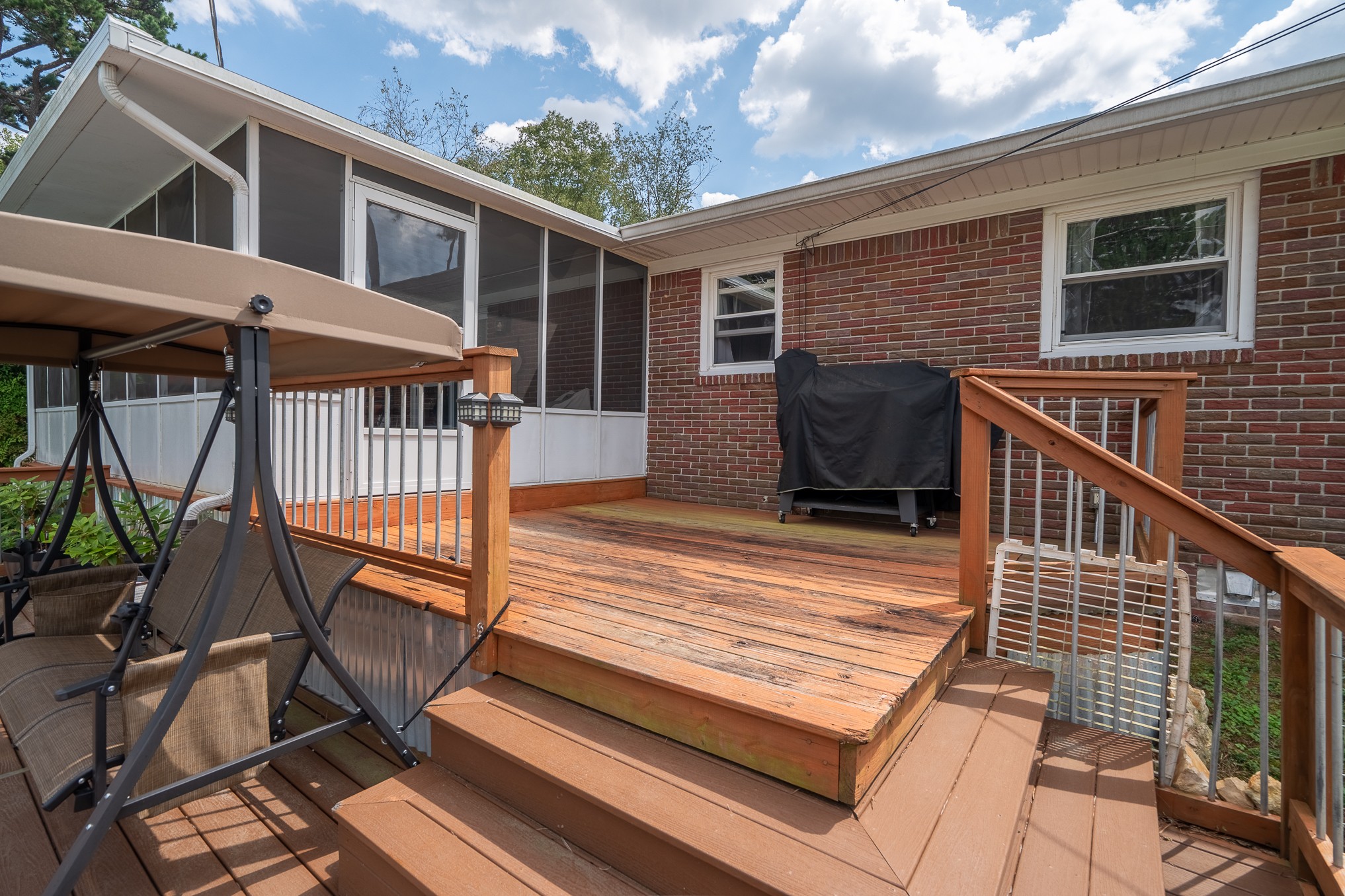12 Horseshoe Bend Road Leoma, TN 38468 - Photo 12 of 51 a view of a patio with two couches and deck with wooden floor and fence