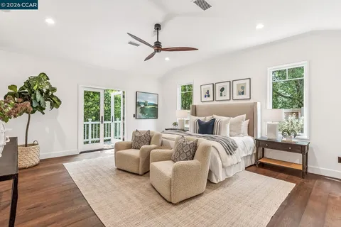 a spacious bedroom with a bed and a couch