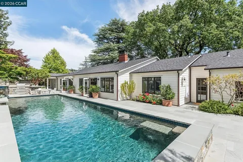 a front view of house with yard outdoor seating and barbeque oven