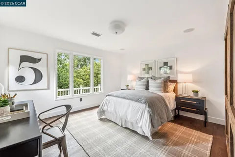 a spacious bedroom with a bed and a window